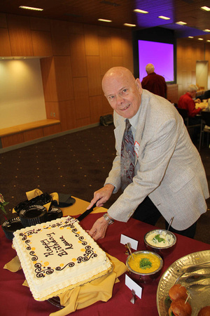 Jim Fordemwalt cuts the birthday cake