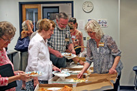 Joy Shearman, Evelyn Partridge, and Bill Moor being served by Barbara Bradford Eschbach