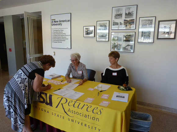 Trudy Perz signs in at the Registration Desk